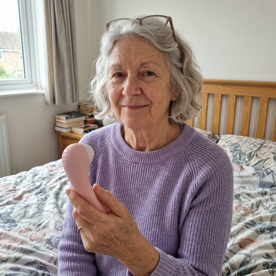 A woman smiling with the Moodie Bloom in bed