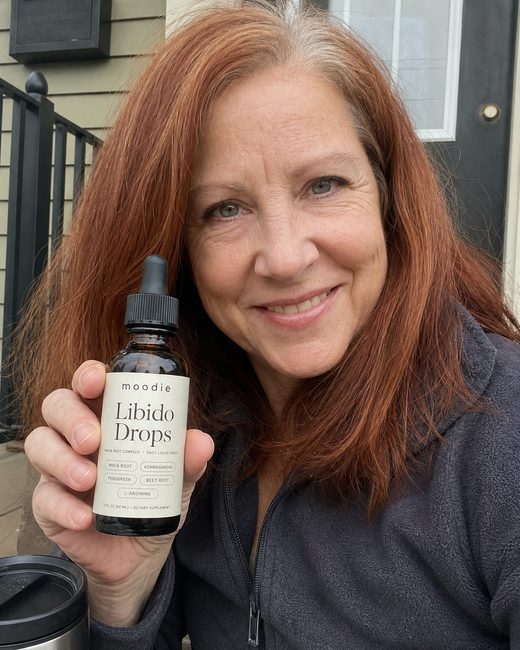 Moodie customer, 58, front porch, holding her bottle of Libido Drops