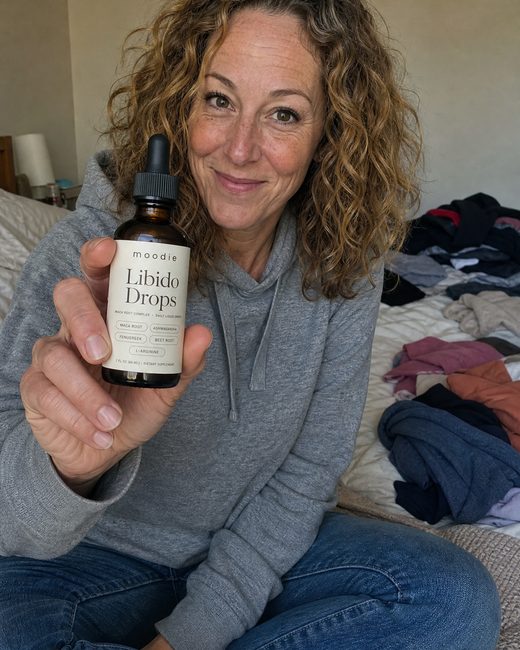 Moodie customer, 47, bedroom, holding her bottle of Libido Drops